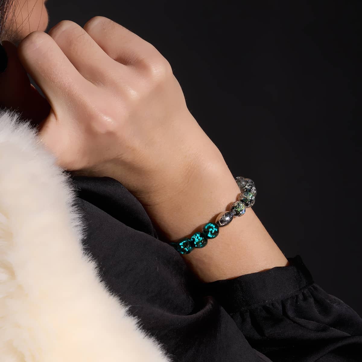 Neon Black Firework Glass Bracelet featuring glowing beads and .925 sterling silver clasp worn on wrist by NOGU